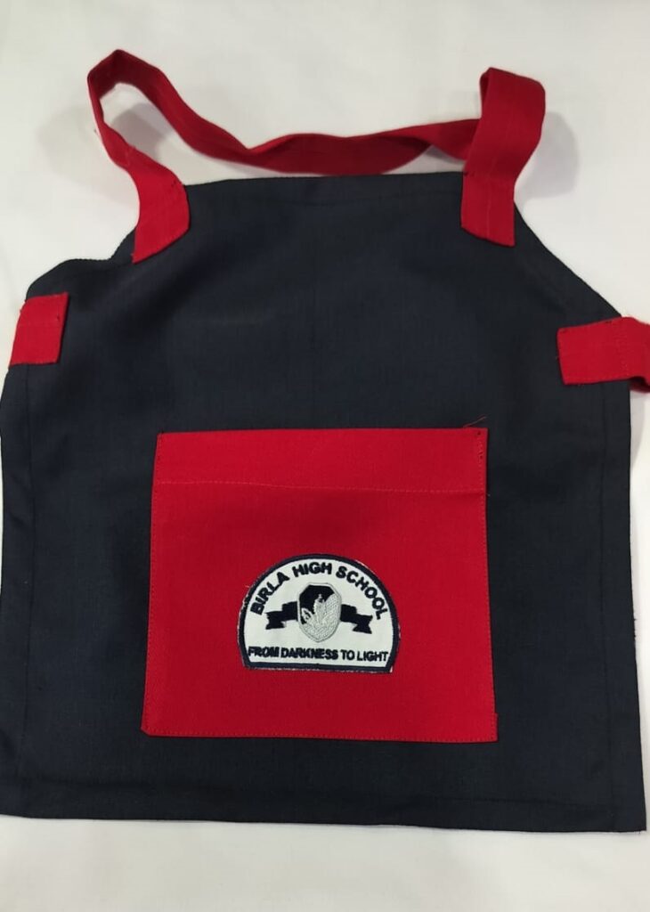 BLUE APRON RED POCKET FOR LOWER NURSARY HSN Code : 6105 – Scholar'S